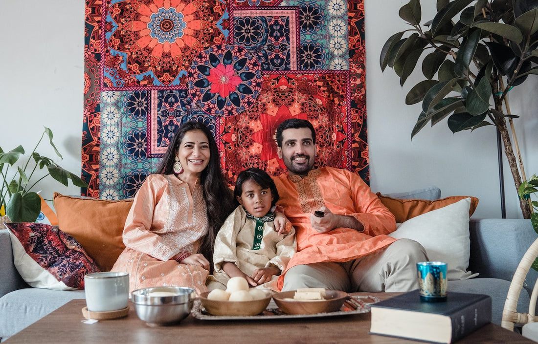 family wearing ethnic wear sitting on the couch 